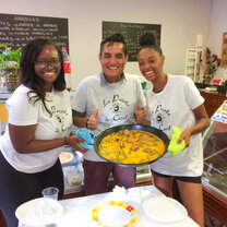 Spanish cooking class Students holding homemade Spanish food